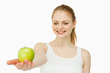 Cheerful woman presenting an apple