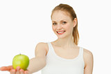Woman smiling while holding an apple