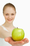 Close up of a woman presenting an apple