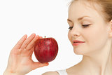 Woman holding an apple while looking at it
