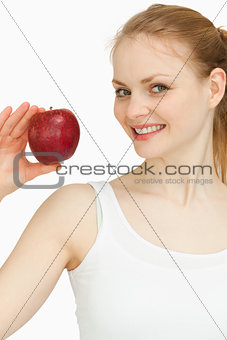 Woman holding an apple while smiling