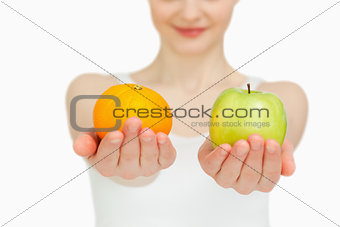 Close up of a woman presenting fruits