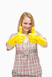 Young woman wearing cleaning gloves while thumbs up