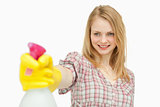 Woman holding a spray bottle while smiling