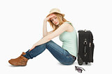 bored woman sitting near a suitcase