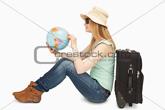 Woman holding a world globe while sitting