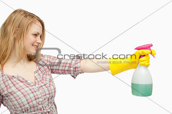 Blond-haired woman holding a spray bottle