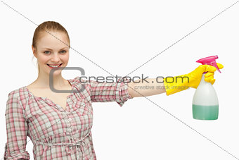 Cheerful woman holding a spray bottle