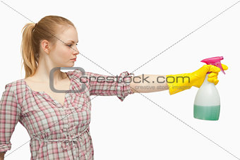 Joyful woman holding a spray bottle