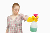 Serious woman holding a spray bottle
