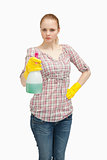 Serious woman holding a spray bottle while standing