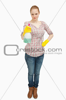 Woman standing while holding a spray bottle