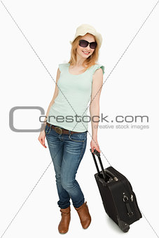 Woman holding a suitcase while standing