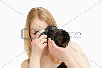 Woman taking a photography with a single-lens reflex camera