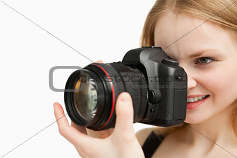 Cheerful woman shooting with a camera
