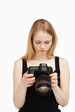 Woman looking at the screen of her camera 