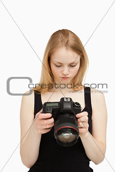 Woman looking at the screen of her camera 