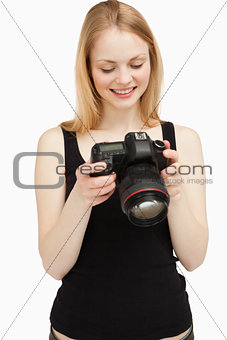 woman looking at her camera wile smiling