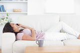 Woman relaxing as she holds a phone