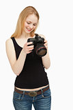 Woman looking at the screen of her camera while smiling
