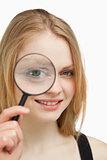 Close up of a woman using a magnifying glass