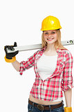 Cheerful woman holding a spirit level