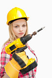 Serious woman holding an electric screwdriver