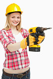 Woman using an electric screwdriver while smiling