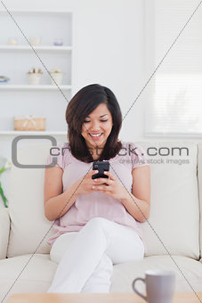 Woman smiling while holding a phone