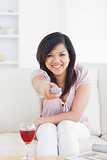 Woman smiling and holding a television remote