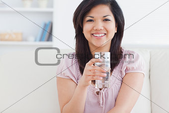 Woman holding a glass full of water