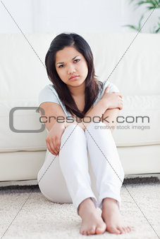 Barefoot woman sitting on the floor 