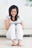 Woman smiling while holding a tactile tablet and a card