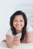 Smiling woman holding a credit card