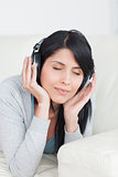 Woman closing her eyes with headphones on