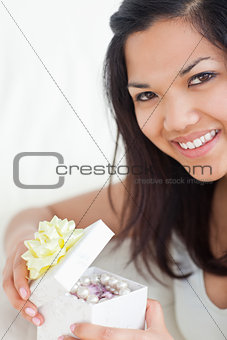 Close-up of a woman opening a gift box