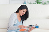 Smiling woman sitting as she reads a magazine