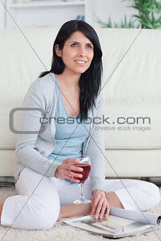 Woman smiling while holding a glass of red wine