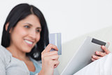 Woman holding a tactile tablet and a credit card