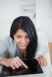 Woman touching a tactile tablet screen while holding a credit ca