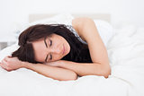 Peaceful woman lying on her white blanket