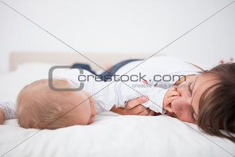 Cute baby placing her hand on the mouth of her mother