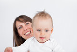 Smiling brunette woman holding her cute baby