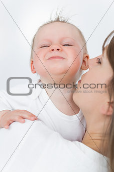 Cute baby being held by her mother