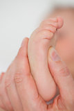 Fingers touching the foot of a baby