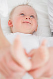 Feet of a laughing baby being held