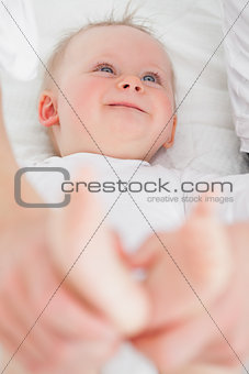 Feet of a laughing baby being held