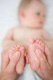 Little feet of a baby being held