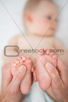 Little feet of a baby being held