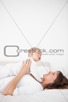 Cheerful woman holding her cute little girl